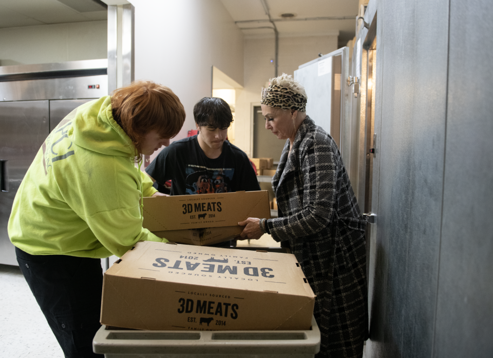 Anthony Columbus, 16, Charles Ford, 15 volunteer at Center of Hope with Lisa Crislip, intervention specialist at Ravenna City Schools.