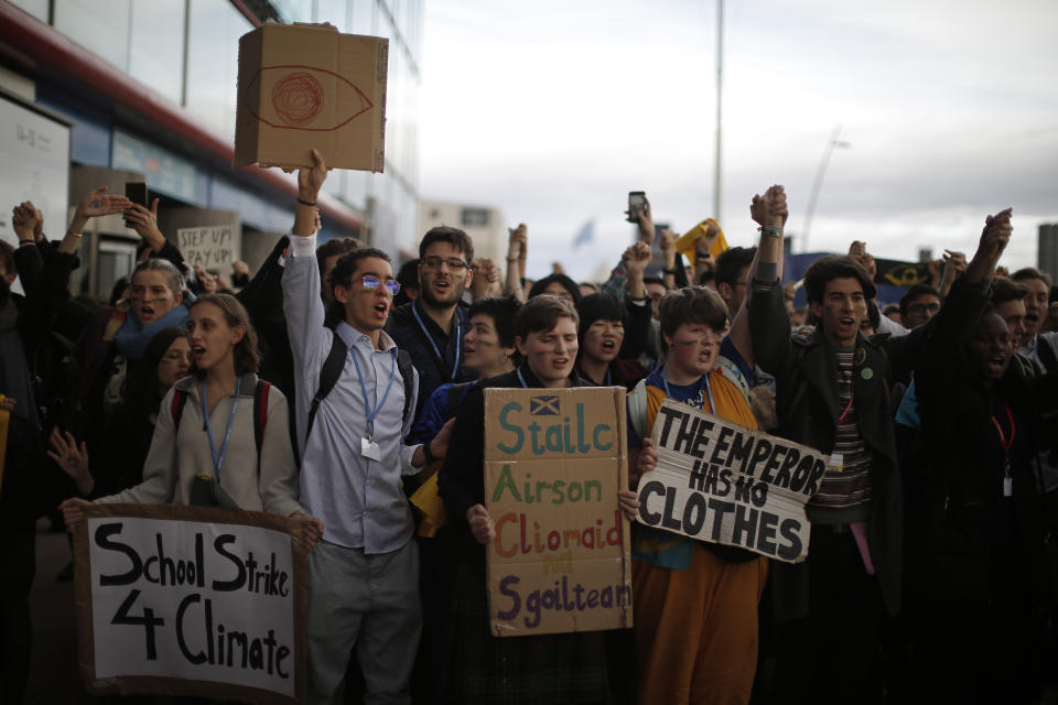 People shout slogans during a march organized by the Fridays for Future international movement of school students outside of the COP25 climate talks congress in Madrid, Spain, Friday, Dec. 13, 2019. The United Nations Secretary-General has warned that failure to tackle global warming could result in economic disaster. (AP Photo/Manu Fernandez)