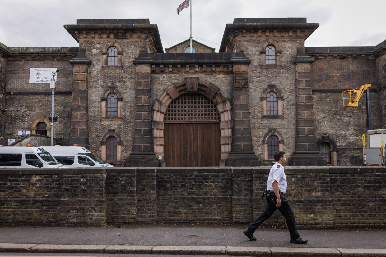 LONDON, ENGLAND - JULY 12: A prison guard walks past HMP Wandsworth prison on July 12, 2024 in London, England. The country's new justice secretary, Shabana Mahmood, announced today that the government will release thousands of prisoners early to alleviate overcrowding. Under the new policy, prisoners on 