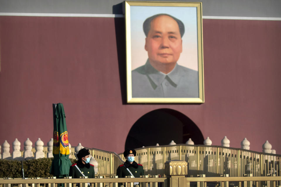 Chinese paramilitary police wearing face masks to protect against the spread of the coronavirus stand guard near the portrait of Chinese leader Mao Zedong on Tiananmen Gate near Tiananmen Square in Beijing, Saturday, Jan. 9, 2021. COVID vaccine shots will be free in China, where more than 9 million doses have been give to date, health officials in Beijing said Saturday. (AP Photo/Mark Schiefelbein)