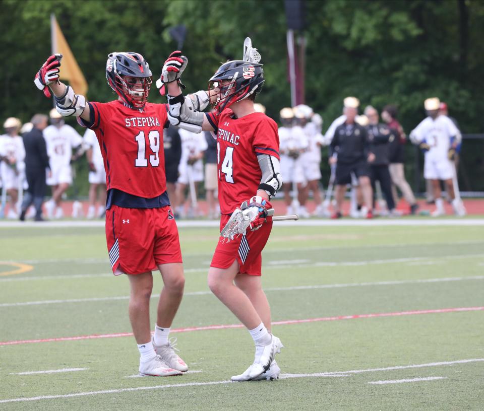 Archbishop Stepinac's Andrew Girolamo, right, and Liam McAlery, celebrate a goal against Iona Prep during the CHSAA NY AA Championship lacrosse game at Iona Prep, May 19, 2022.  Archbishop Stepinac beat Iona Prep 6-5.