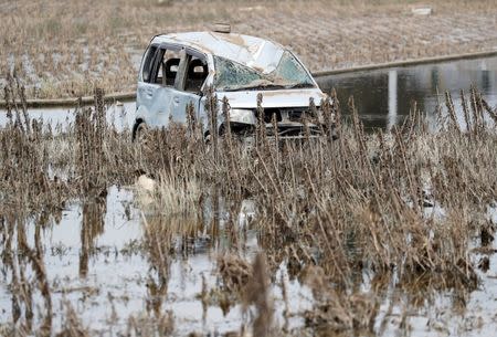 A submerged car is seen in a flooded area in Mabi town in Kurashiki, Okayama Prefecture, July 13, 2018. REUTERS/Issei Kato