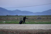 A migrant walks near Pournara refugee camp on the outskirts of divided capital Nicosia, Cyprus, Saturday, Jan. 28, 2023. Cypriots are voting Sunday for a new president who they’ll expect to decisively steer the small island nation through shifting geopolitical sands and uncertain economic times that have become people's overriding concern, eclipsing stalemated efforts to remedy the country’s ethnic division. (AP Photo/Petros Karadjias)