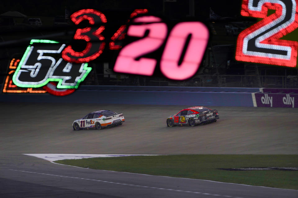 Denny Hamlin (11) races in front of Martin Truex Jr. (19) during a NASCAR Cup Series auto race Sunday, June 25, 2023, in Lebanon, Tenn. (AP Photo/George Walker IV)