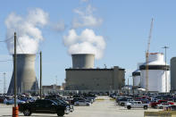 FILE -- Reactors for Unit 3 and 4 sit at Georgia Power's Plant Vogtle nuclear power plant on Jan. 20, 2023, in Waynesboro, Ga., with the cooling towers of older Units 1 and 2 billowing steam in the background. Company officials announced Monday, July 31, 2023, that Unit 3 has reached commercial operation after years of delays and billions in cost overruns. (AP Photo/John Bazemore, File)