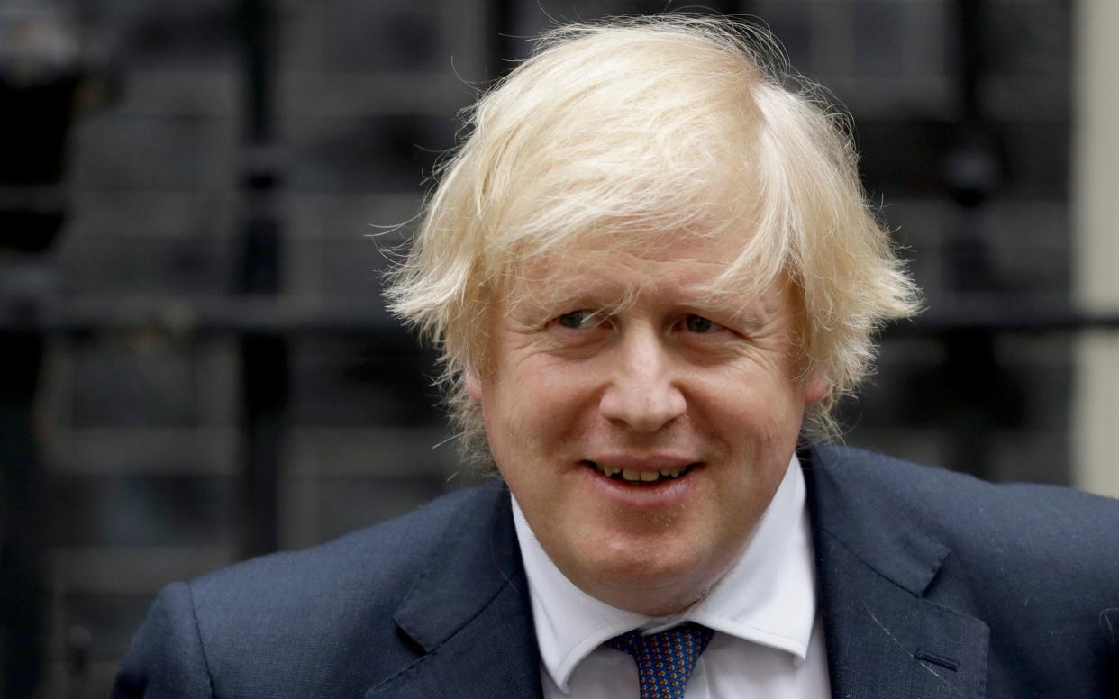 British Prime Minister Boris Johnson leaves 10 Downing Street in London, to attend the weekly Prime Minister's Questions at the Houses of Parliament - AP