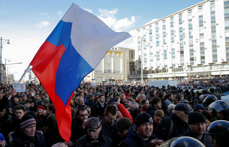 Protesters wave a Russian flag during a rally in Moscow.