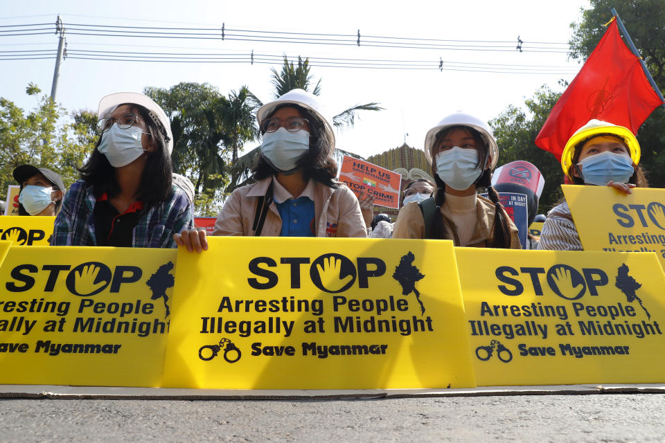 Mandalay University graduates hold posters that say "Stop Arresting People illegally at midnight" "Save Myanmar" during an anti-coup protest in Mandalay, Myanmar, Sunday, Feb. 14, 2021. Daily mass street demonstrations in Myanmar are on their second week, with neither protesters nor the military government they seek to unseat showing any signs of backing down from confrontations. (AP Photo)