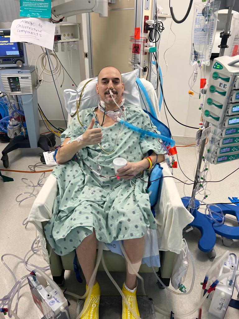 Plymouth resident Tim Cornett gives the thumb's up nine hours after double-lung transplant surgery at Jackson Memorial Hospital in Miami.