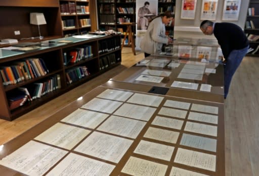 Visitors look at some of Albert Einstein?s manuscripts on display in the Jerusalem's Hebrew University of Jerusalem