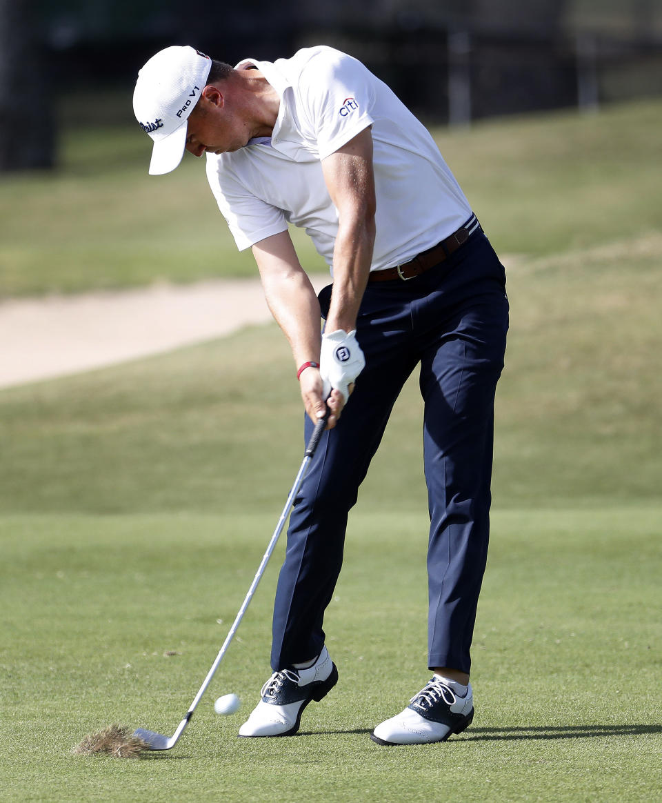 Justin Thomas hits his approach shot from the ninth fairway during the first round of the Sony Open PGA Tour golf event, Thursday, Jan. 10, 2019, at the Waialae Country Club in Honolulu, Hawaii. (AP Photo/Matt York)