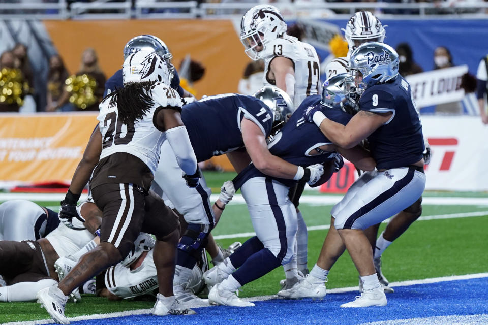 Nevada running back Devonte Lee is pushed into the end zone for a touchdown during the first half of the Quick Lane Bowl NCAA college football game against Western Michigan, Monday, Dec. 27, 2021, in Detroit. (AP Photo/Carlos Osorio)
