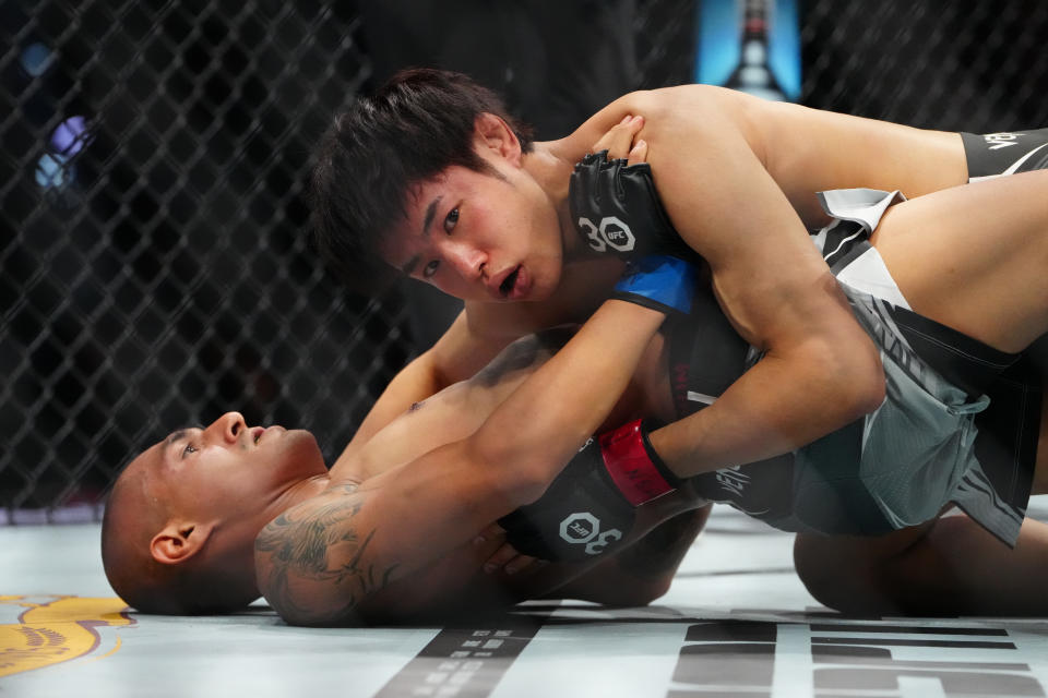 Jul 8, 2023; Las Vegas, Nevada, USA; Tatsuro Taira (red gloves) fights Edgar Chairez (blue gloves) during UFC 290 at T-Mobile Arena. Mandatory Credit: Stephen R. Sylvanie-USA TODAY Sports