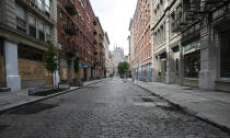 A SoHo street is deserted, Wednesday, June 3, 2020, in New York. There's a certain kind of silent on the streets of Manhattan. Not the "summertime and the living is easy" vacation lull, or the post-Christmas holidays letdown. It's the only-person-in-the-empty-house kind of quiet now. The New York City immortalized in song and scene has been swapped out for the last few months with the virus version. (AP Photo/Mark Lennihan)