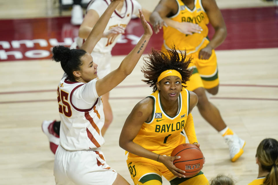 FILE - Baylor forward NaLyssa Smith (1) drives to the basket around Iowa State forward Kristin Scott, left, during the second half of an NCAA college basketball game in Ames, Iowa, in this Sunday, Jan. 31, 2021, file photo. Smith made The Associated Press All-America first team, announced Wednesday, March 17, 2021. (AP Photo/Charlie Neibergall, File)