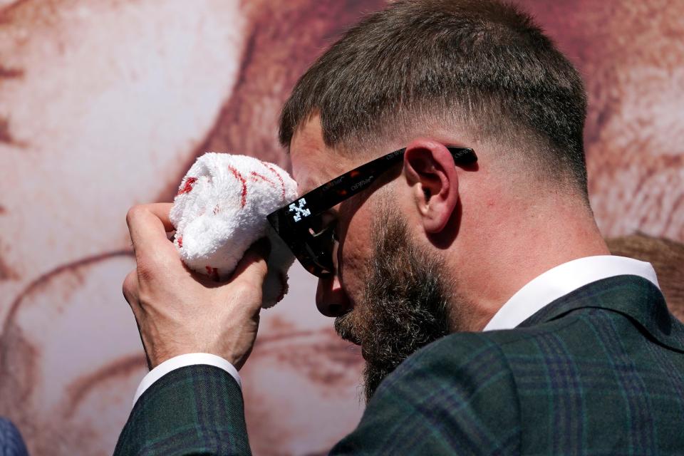 Undefeated IBF Super Middleweight champion Caleb Plant wipes his head after being cut in a scuffle with unified WBC/WBO/WBA super middleweight champion Canelo Alvarez.