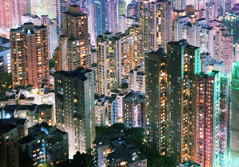 China, Hong Kong, apartment blocks, at night, elevated view.