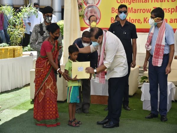 Assam Health Minister Himanta Biswa Sarma handed over air tickets to children who will fly to Bengaluru and Kolkata for cardiac surgery and bone marrow transplant. (Photo: Himanta Biswa Sarma Twitter)