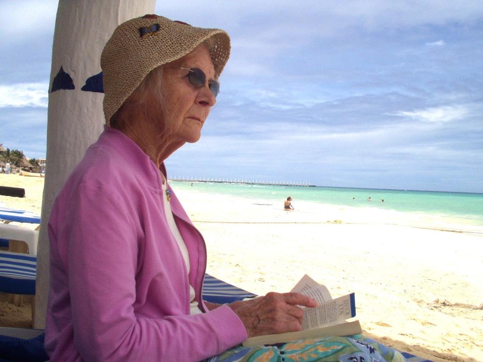 Caitlin Weaver's grandmother reading at the beach.