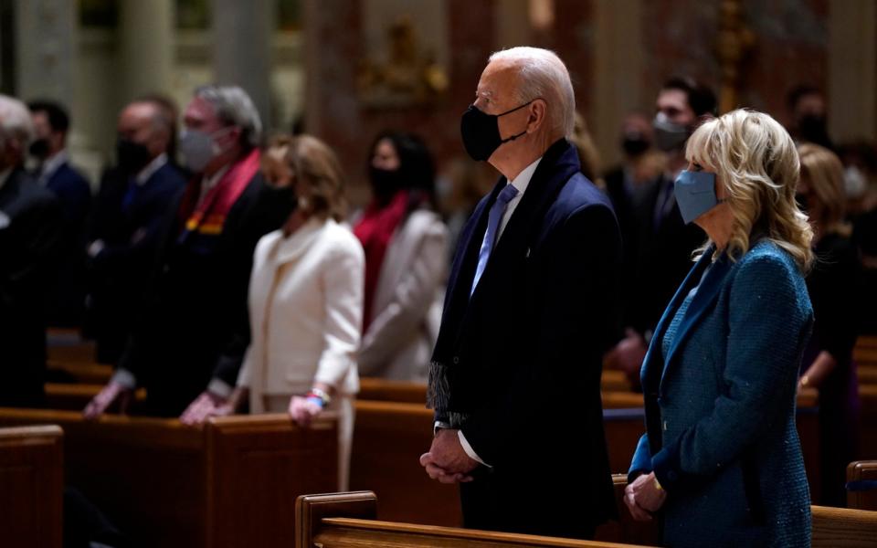 President-elect Joe Biden is joined his wife Jill Biden as they celebrate Mass at the Cathedral of St. Matthew the Apostle during Inauguration Day ceremonies - Evan Vucci/AP