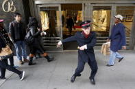 Salvation Army Bell Ringer Nate Hinzman dances for Black Friday shoppers outside Bloomingdales department in the Manhattan borough of New York, November 27, 2015. REUTERS/Brendan McDermid