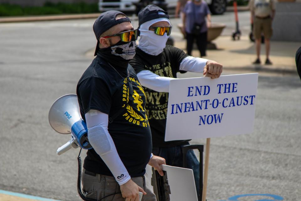 Outside of the Tippecanoe County Courthouse, Proud Boys members Thomas and Joseph, demonstrated against the 'Bans Off Our Bodies' protest, on May 14, 2022, in Lafayette. "End the infant-o-caust now," reads the sign.