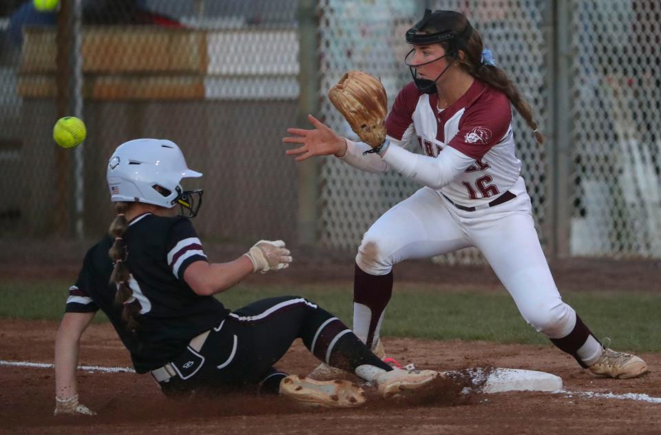 Appoquinimink's Lauren Foltz slides safely into third base as Caravel's Haley Grygo awaits the throw on a sac fly in the third inning of the Bucs' 7-2 win Thursday, May 4, 2023 at Caravel.