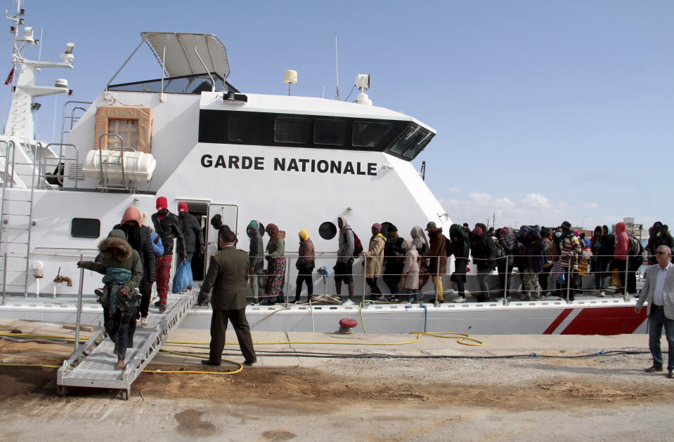 Migrants board a vessel after getting stopped by Tunisian Maritime National Guard at sea during an attempt to get to Italy, near the coast of Sfax, Tunisia, Tuesday, April 18, 2023. The Associated Press, on a recent overnight expedition with the National Guard, witnessed migrants pleading to continue their journeys to Italy in unseaworthy vessels, some taking on water. Over 14 hours, 372 people were plucked from their fragile boats. (AP Photo)