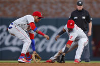 Philadelphia Phillies second baseman Jean Segura (2) fields a ball as he is backed up by shortstop Johan Camargo in the third inning of a baseball game against the Atlanta Braves, Tuesday, May 24, 2022, in Atlanta. (AP Photo/Todd Kirkland)