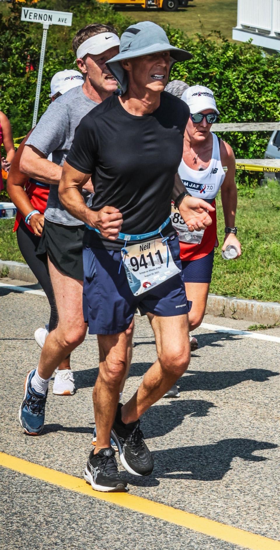 Neil Levine, of Mansfield, a co-owner of Maguire's Bar and Grill in Easton, runs his 41st Falmouth Road Race on Aug. 20, 2023, just weeks after finishing chemotherapy for cancer treatment.