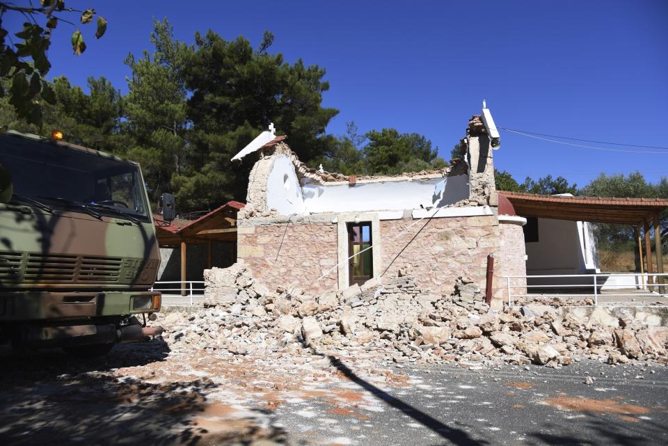 A military truck passes near a damaged Greek Orthodox chapel after a strong earthquake in Arcalochori village on the southern island of Crete, Greece, Monday, Sept. 27, 2021. A strong earthquake with a preliminary magnitude of 5.8 has struck the southern Greek island of Crete, and Greek authorities say one person has been killed and several more have been injured. (AP Photo/Harry Nakos)