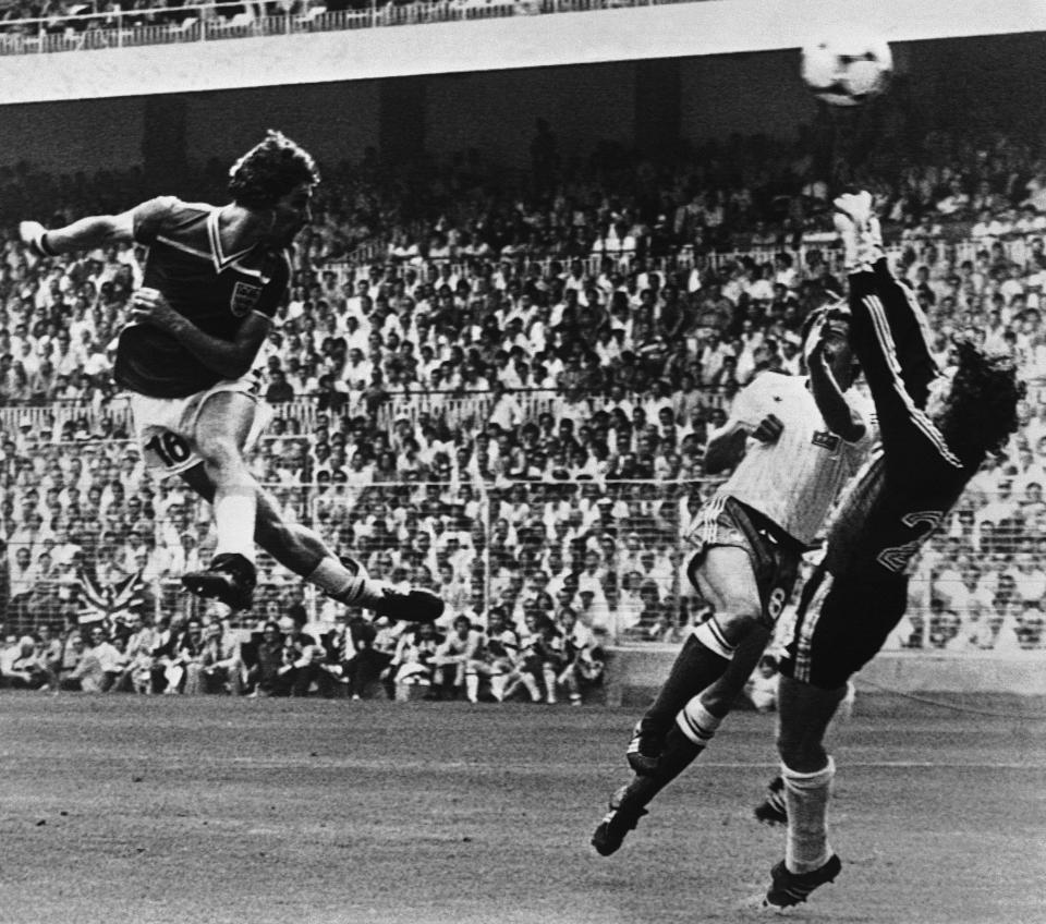 FILE - In this June 16, 1982 file photo England's Bryan Robson, left, heads the ball past French goalkeeper Jean Ettori, right, and defender Christian Lopez, to score his and England's second goal during the World Cup soccer match between England and France in Sam Manes Stadium, Bilbao. England defeated France 3-1. (AP Photo, File)