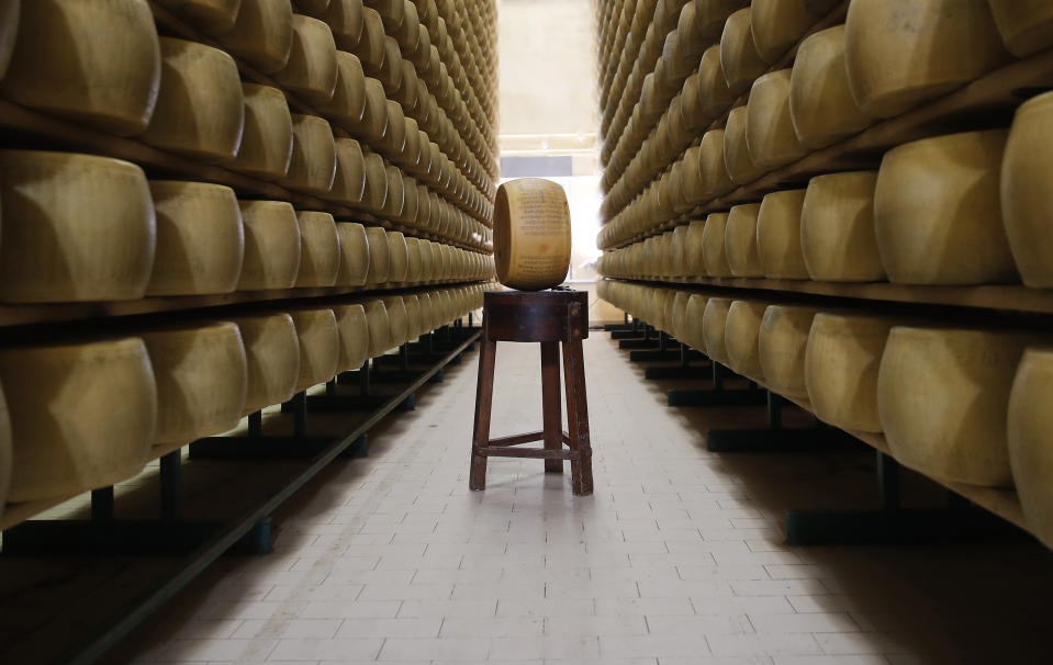 In this photo taken Tuesday, Oct. 8, 2019, Parmigiano Reggiano Parmesan cheese wheels are stored in Noceto, near Parma, Italy. U.S. consumers are snapping up Italian Parmesan cheese ahead of an increase in tariffs to take effect next week. The agricultural lobby Coldiretti on Friday, Oct. 11, 2019, said sales of both Parmigiano Reggiano and Grana Padano, aged cheeses defined by their territory of origin, have skyrocketed by 220% since the higher tariffs were announced one week ago. (AP Photo/Antonio Calanni)