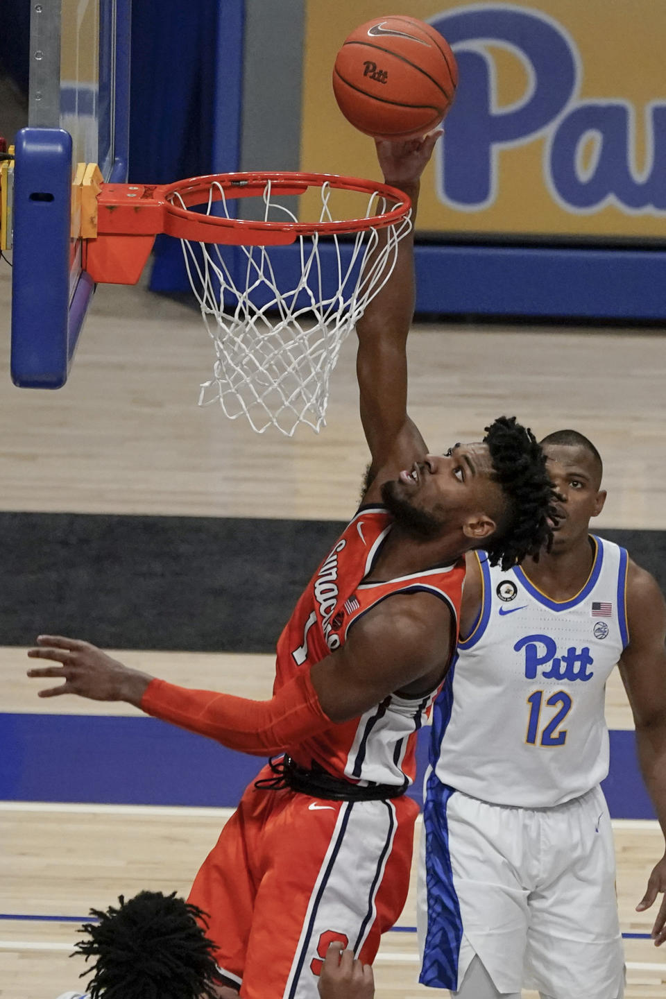 Syracuse's Quincy Guerrier (1) scores as Pittsburgh's Abdoul Karim Coulibaly (12) watches from behind during the second half of an NCAA college basketball game, Saturday, Jan. 16, 2021, in Pittsburgh. (AP Photo/Keith Srakocic)