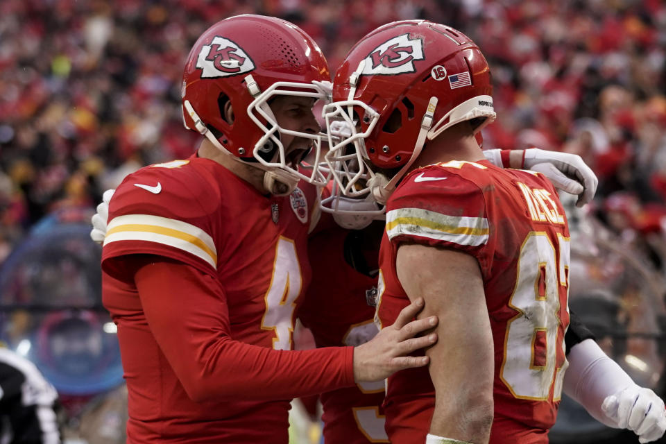 Kansas City Chiefs tight end Travis Kelce (87) celebrates his touchdown with quarterback Chad Henne (4) against the Jacksonville Jaguarsduring the first half of an NFL divisional round playoff football game, Saturday, Jan. 21, 2023, in Kansas City, Mo. (AP Photo/Ed Zurga)