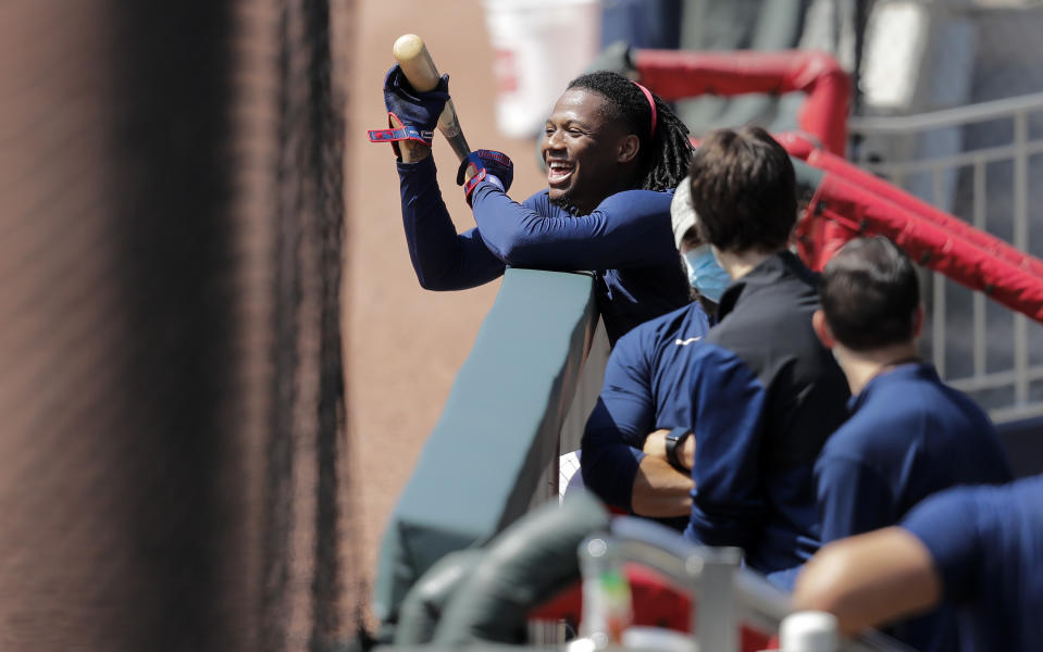 Atlanta Braves' Ronald Acuña Jr., laughs in the dugout during team practice at Truist Park on Sunday, July 5, 2020, in Atlanta. (AP Photo/Brynn Anderson)