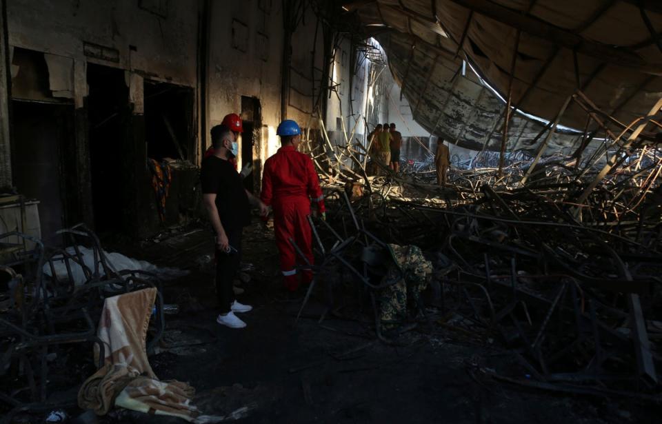 Firefighters work at the site of a fatal fire, in the district of Hamdaniya, Nineveh province, Iraq, Wednesday, 27 September2023 (AP)