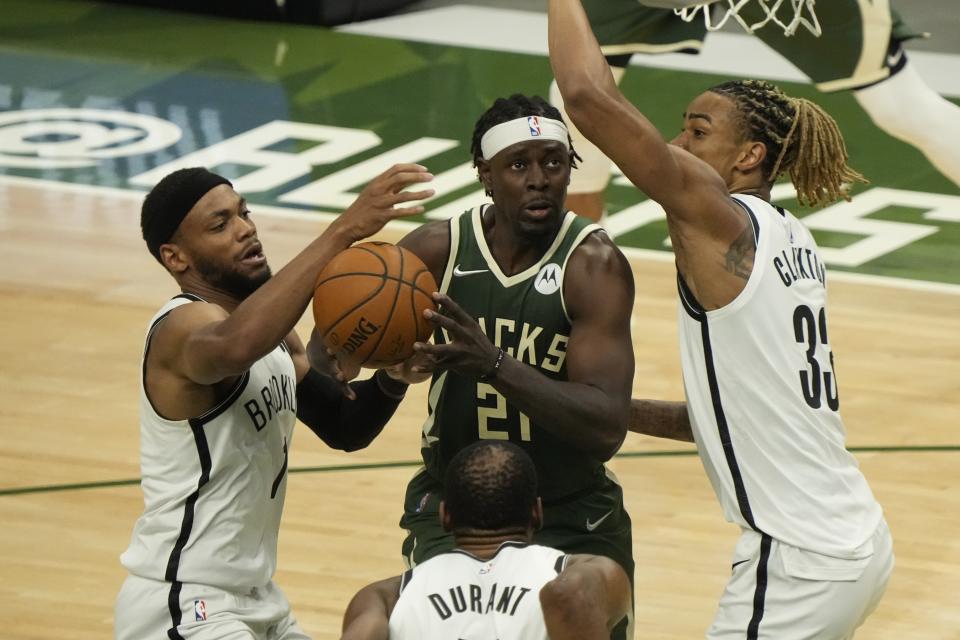 Milwaukee Bucks' Jrue Holiday tries to drive in traffic during the first half of Game 3 of the NBA Eastern Conference basketball semifinals game against the Brooklyn NetsThursday, June 10, 2021, in Milwaukee. (AP Photo/Morry Gash)