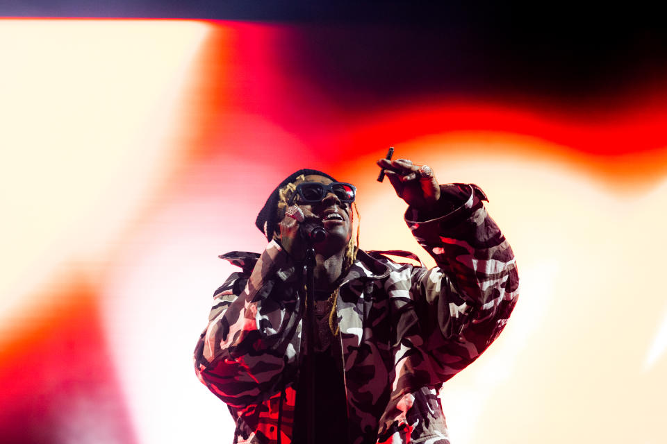 Lil Wayne wearing camouflage onstage