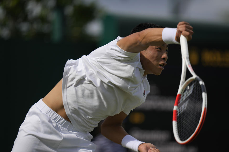 Brandon Nakashima of the US returns to Canada's Denis Shapovalov in a second round men's single match on day four of the Wimbledon tennis championships in London, Thursday, June 30, 2022. (AP Photo/Alastair Grant)