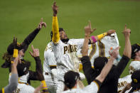 San Diego Padres' Fernando Tatis Jr., center, celebrates with teammates after the Padres defeated the St. Louis Cardinals 4-0 in Game 3 of a National League wild-card baseball series Friday, Oct. 2, 2020, in San Diego. The Padres won the series and advanced to the Division Series. (AP Photo/Gregory Bull)