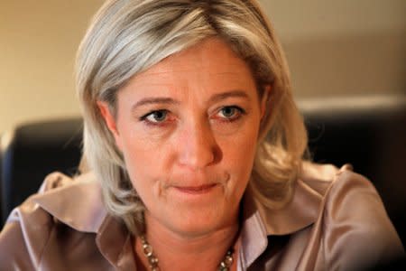 FILE PHOTO: Marine Le Pen, France's far-right National Front political party vice-president and European deputy, listens during an interview with Reuters at the party's headquarters in Nanterre near Paris, France, December 7, 2010. REUTERS/Charles Platiau/File Photo