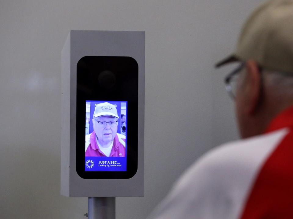 A passenger boarding flight 773 to Aruba uses JetBlue's facial-recognition system at Logan Airport in Boston on Jun. 15, 2017.