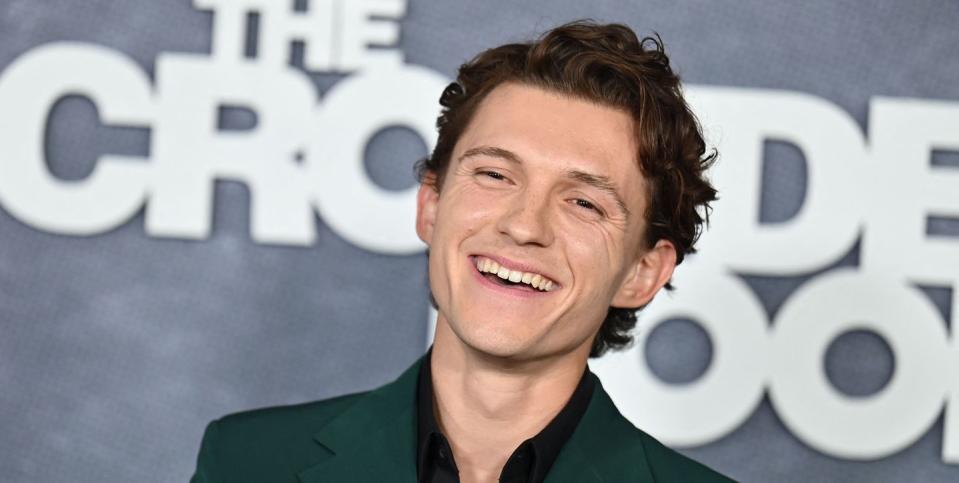tom holland wearing a green velvet suit at the premiere of the crowded room