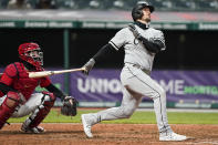 Chicago White Sox's Yasmani Grandal watches his ball after hitting a two-run home run in the sixth inning in a baseball game against the Cleveland Indians, Tuesday, April 20, 2021, in Cleveland. Indians catcher Roberto Perez watches. (AP Photo/Tony Dejak)