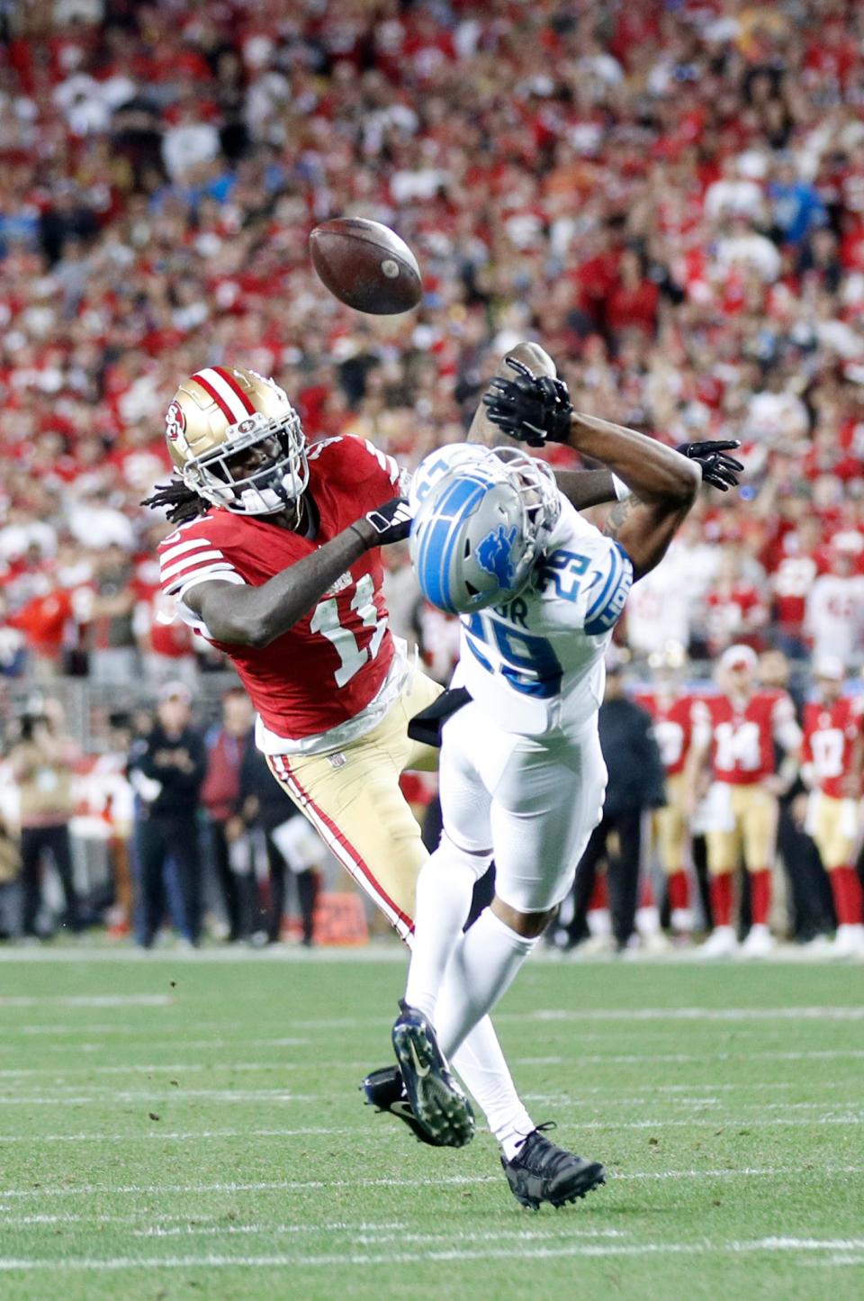 49ers wide receiver Brandon Aiyuk catches the ball after a ricochet off Lions cornerback Kindle Vildor in the third quarter of the NFC championship game at Levi's Stadium in Santa Clara, California, on Sunday, Jan. 28, 2024.