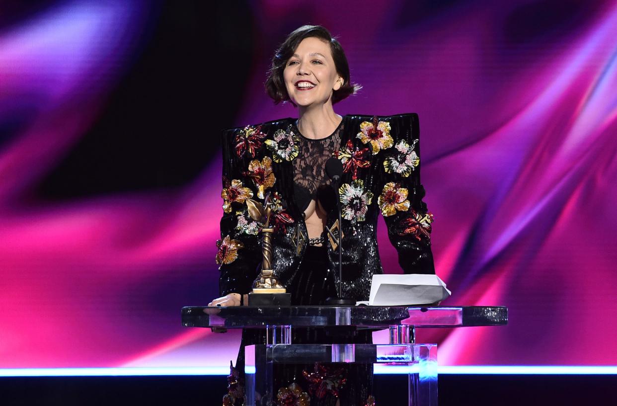 Maggie Gyllenhaal accepts the award for best screenplay for 