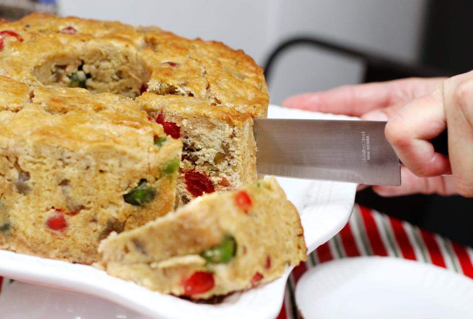 Shannon Tinsley, owner of SweetNanaCakes in Staunton, makes fruitcakes for customers during the holiday season. The dense candied fruit and nut-filled cakes tip the scales at over 6 lbs.