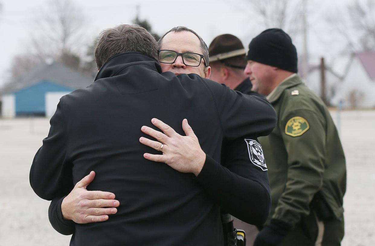 ​Perry Police Chief Eric Vaughn hugs a fellow officer after a news conference about a shooting at Perry High School on Thursday, Jan. 4, 2024. Multiple people were injured and the shooter died from a self-inflicted gunshot wound.