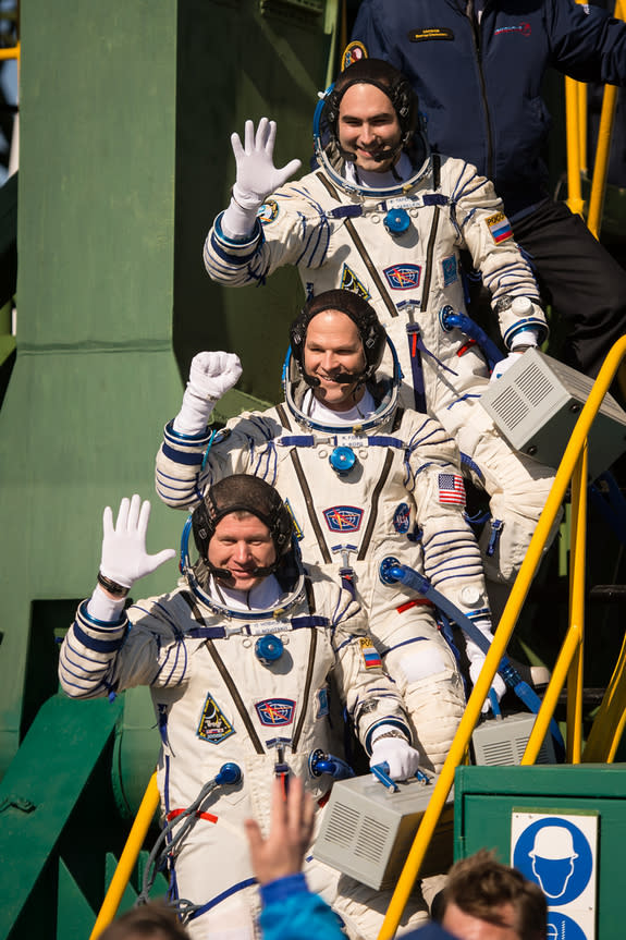 Expedition 33/34 crew members, Soyuz Commander Oleg Novitskiy, bottom, Flight Engineer Kevin Ford of NASA, and Flight Engineer Evgeny Tarelkin of ROSCOSMOS, top, wave farewell before boarding their Soyuz rocket just a few hours before their lau